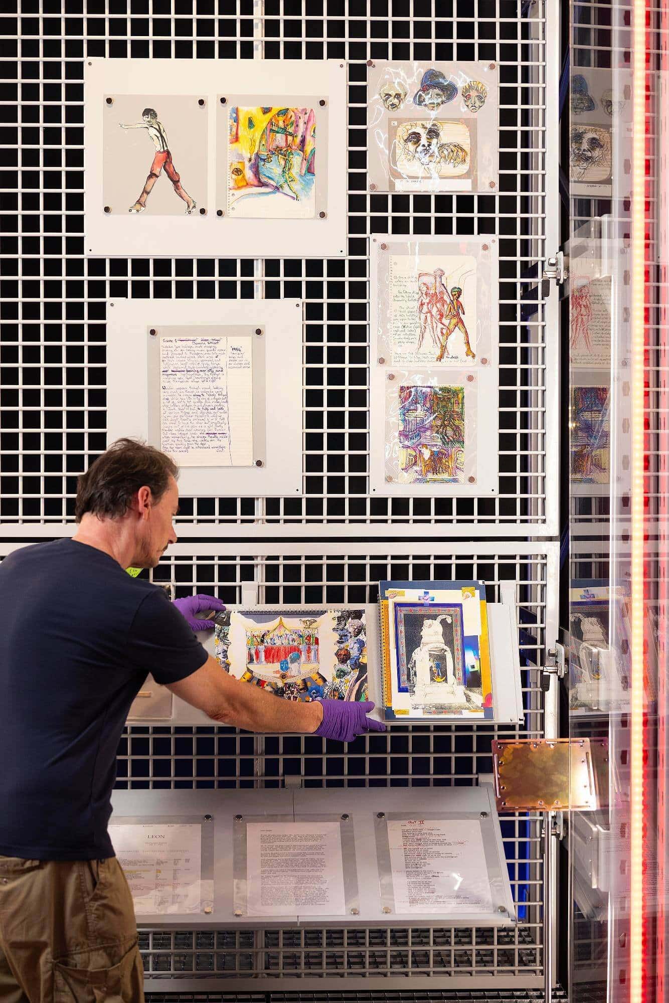 A V&A Technician applies finishing touches to a display of David Bowie’s ‘Unrealised Projects’.