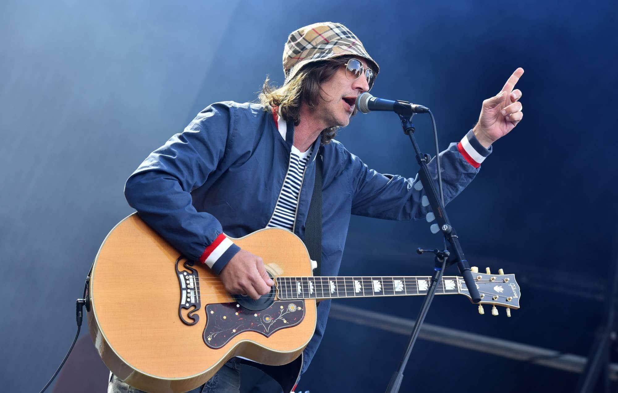 Richard Ashcroft with Oasis, highlighting their enduring connection.