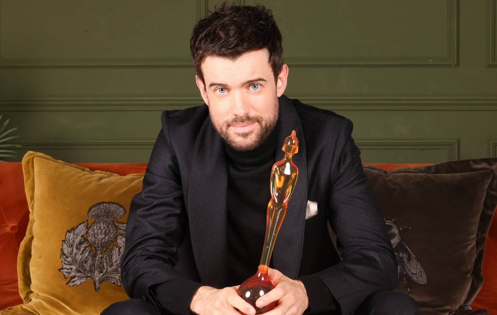 Jack Whitehall holding BRIT Award trophy