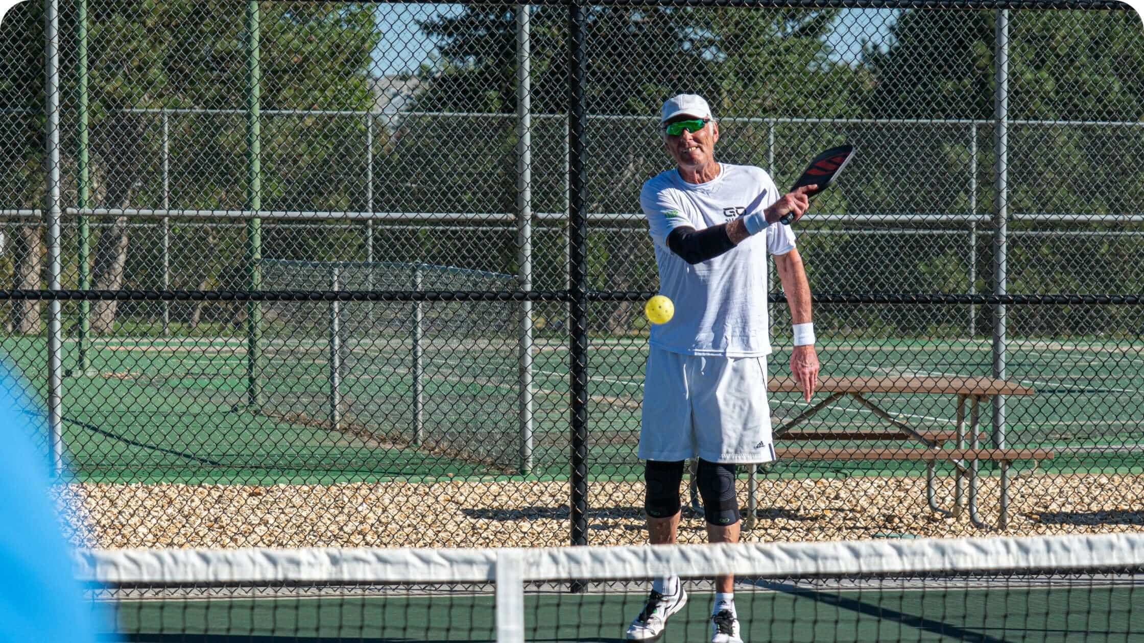Rick Barry playing pickleball wearing knee and elbow sleeves
