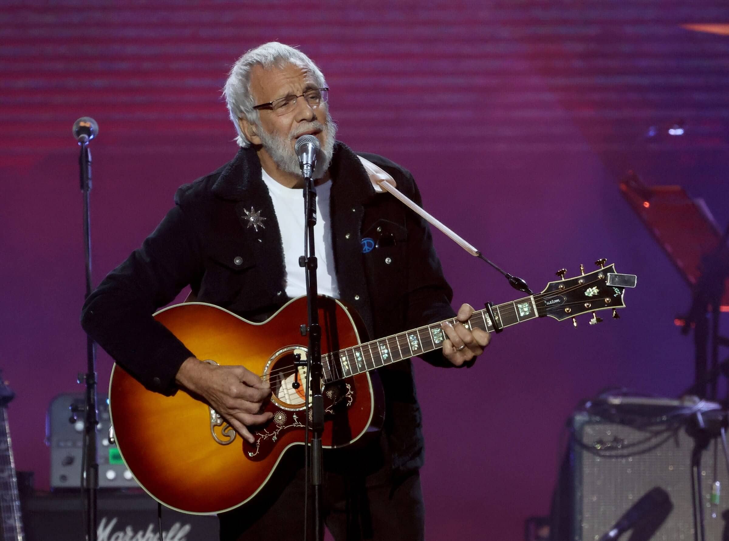 Yusuf / Cat Stevens on stage, a timeless figure in music history.