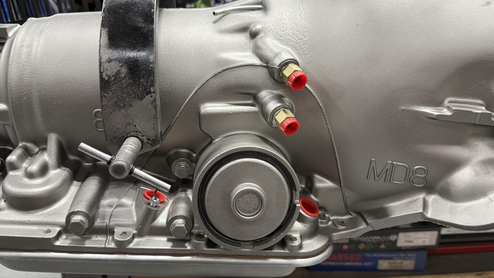 Passenger side of a 1987 and later 700R4 case showing the cast arch running over the servo and cooler fittings