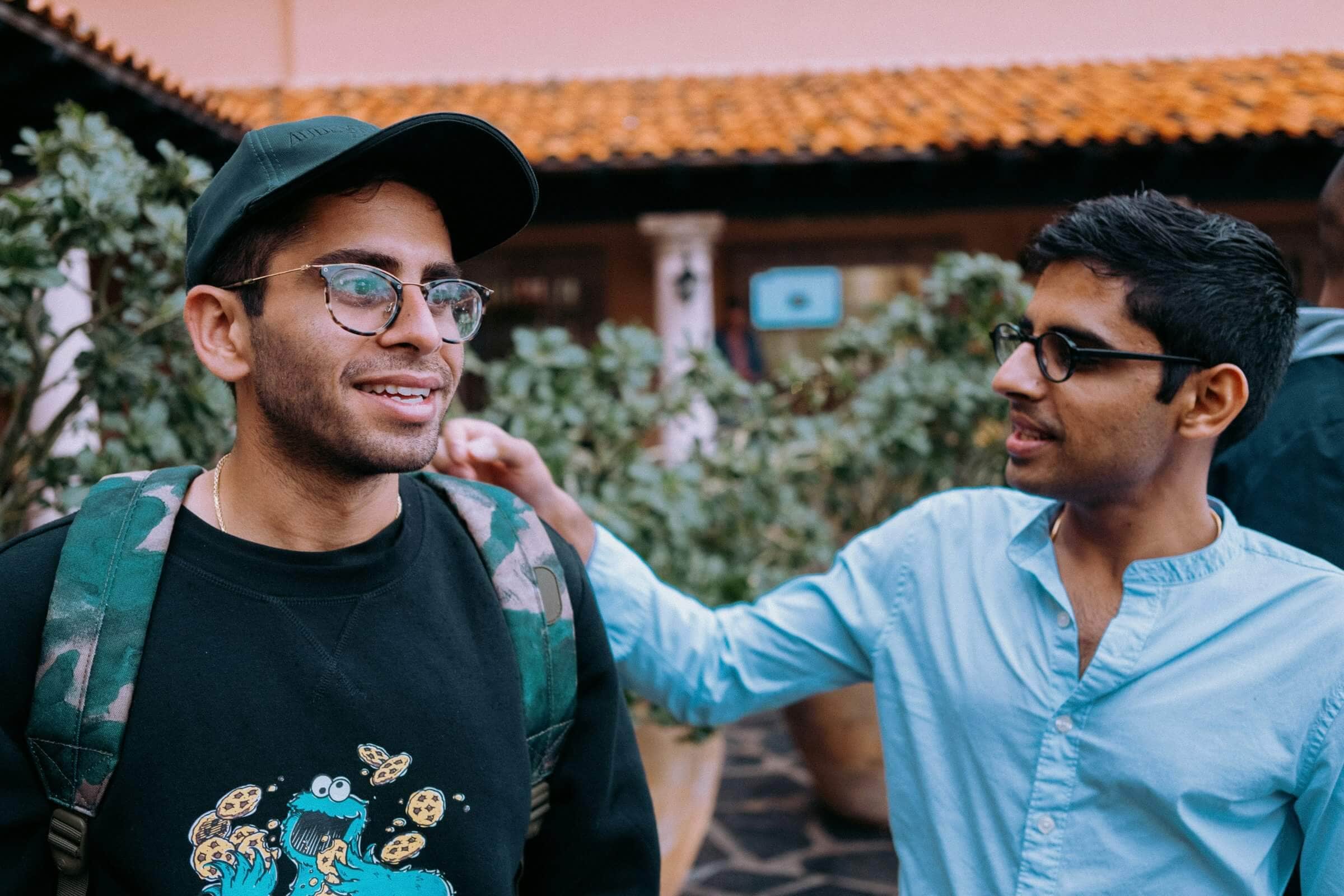 Man friends shoulder to shoulder