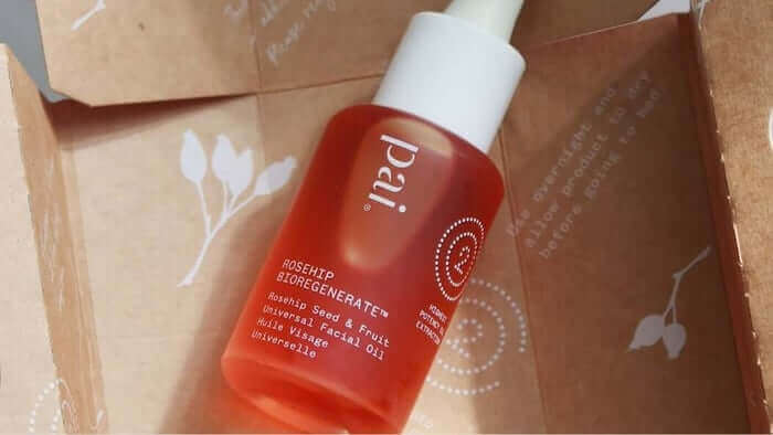 Pai Rosehip BioRegenerate Oil bottle with white pump dispenser nestled in sustainable kraft paper packaging