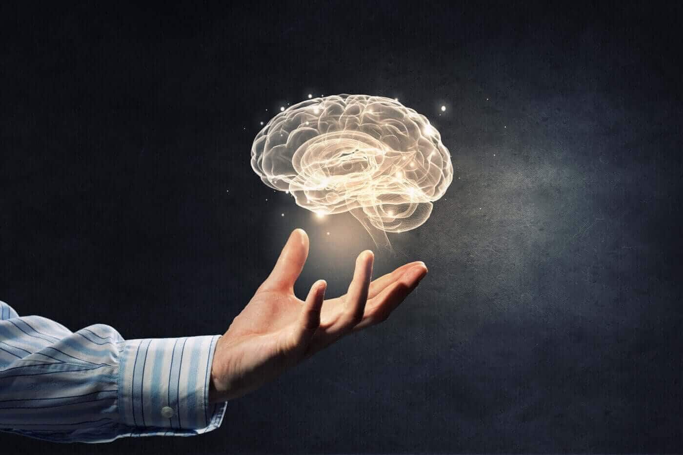 Glowing illustration of a brain above an open hand, representing reviewer mental health in redaction work