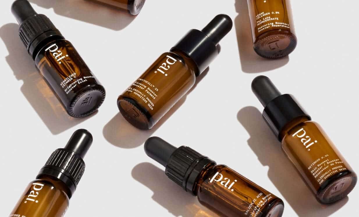 Pai Retinoid 0.3% vitamin A booster bottles arranged on white surface with dramatic shadows