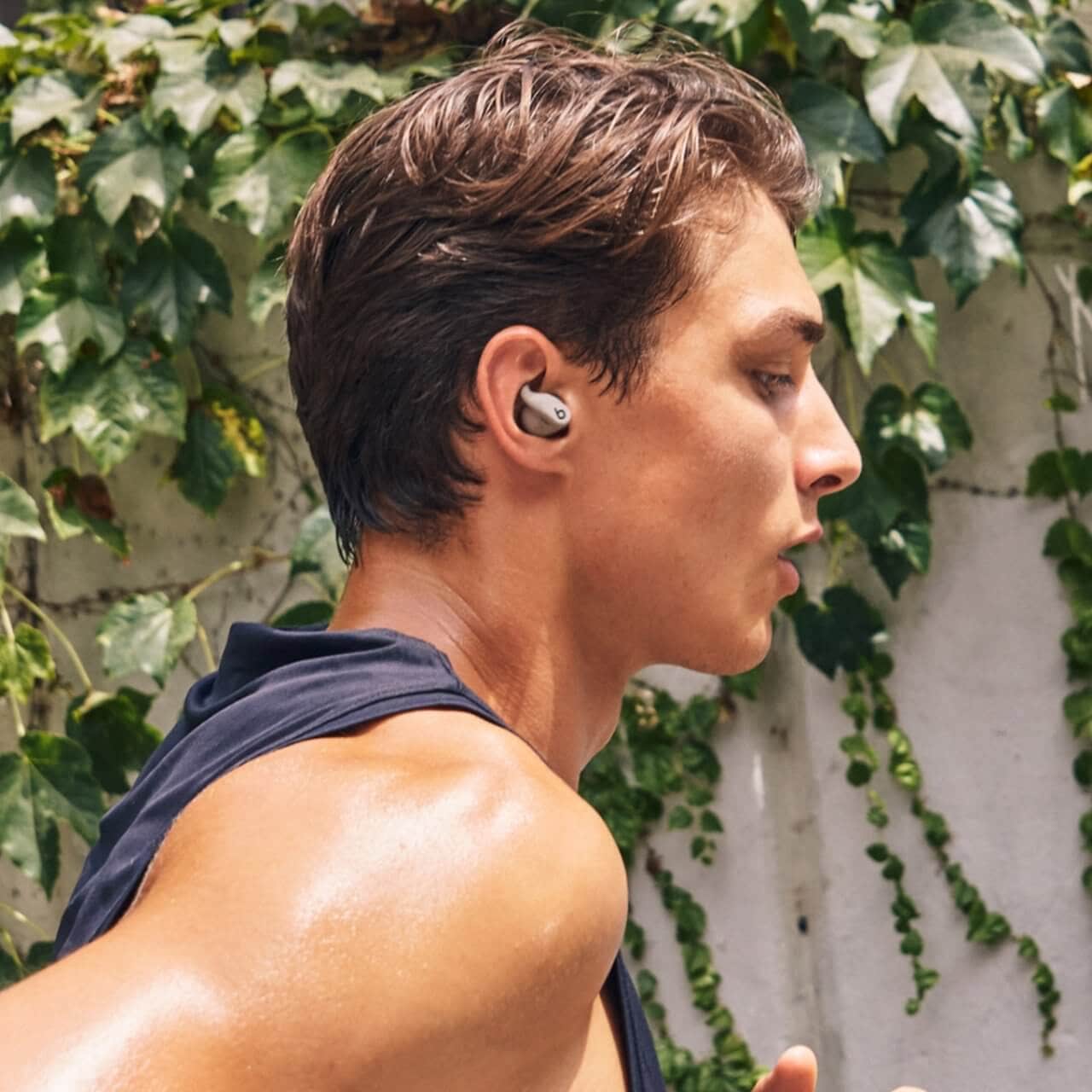 Powerbeats Fit earbuds and charging case close-up