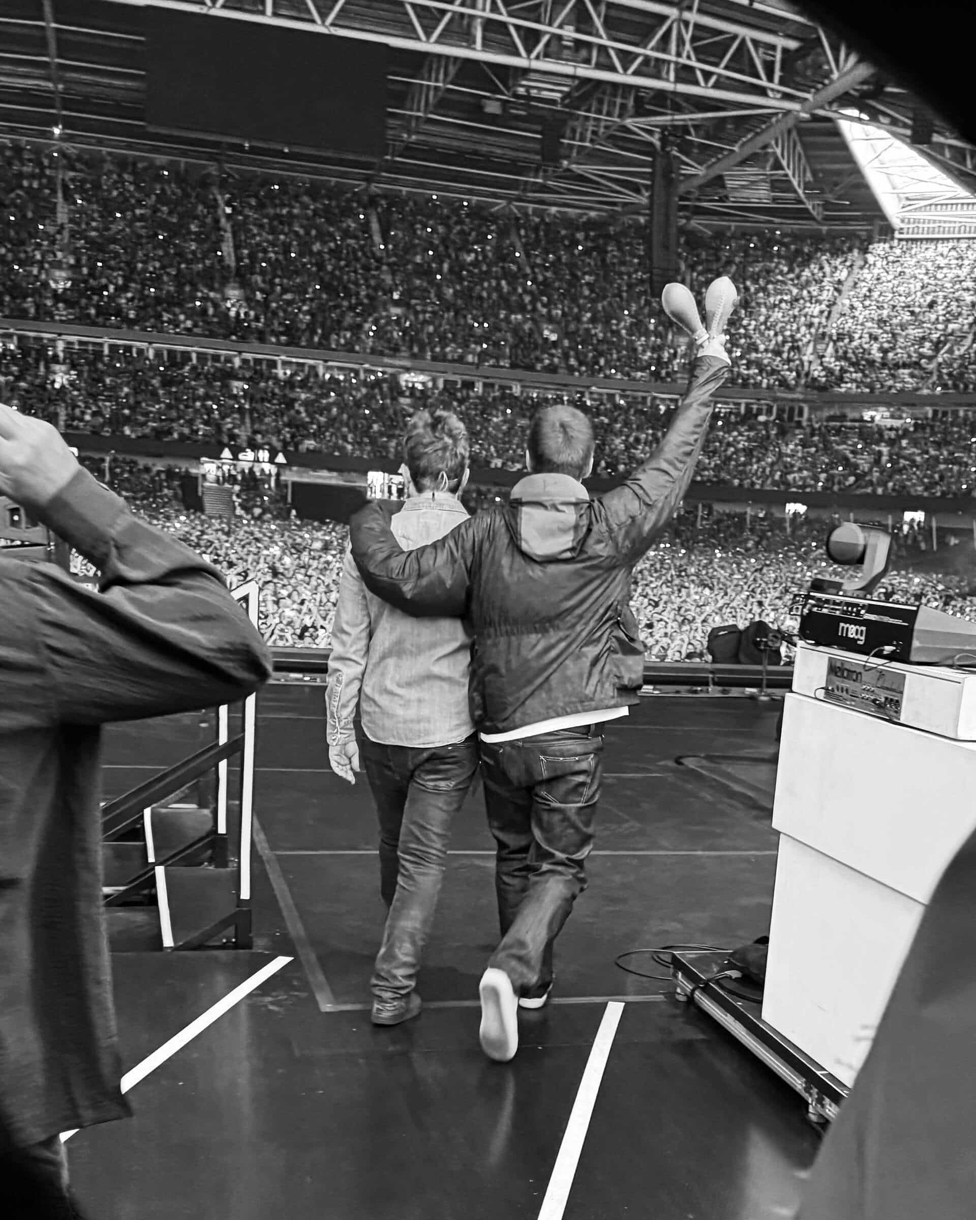 Noel and Liam Gallagher performing with Oasis at Cardiff Principality Stadium