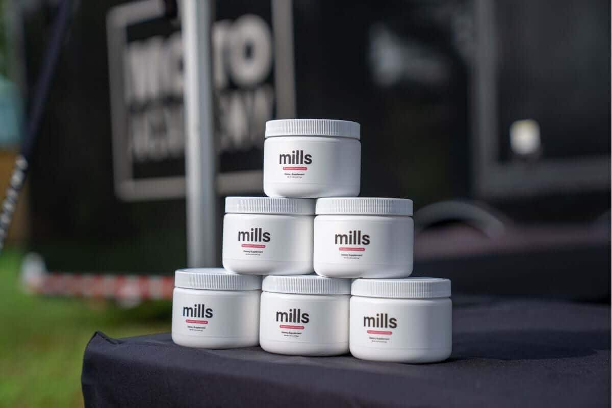 Mills raspberry lemonade electrolyte powder stacked on the Moto Academy trailer table at a 5-Day Camp.