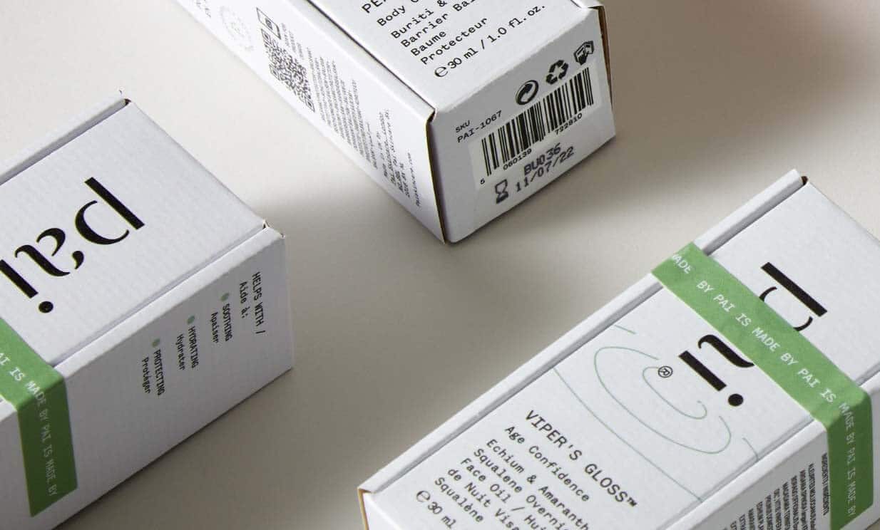 Pai Skincare white product boxes with green sustainable packaging labels