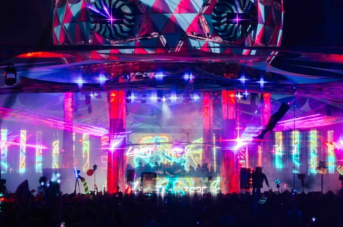 Beautifully lit stage with festival crowd