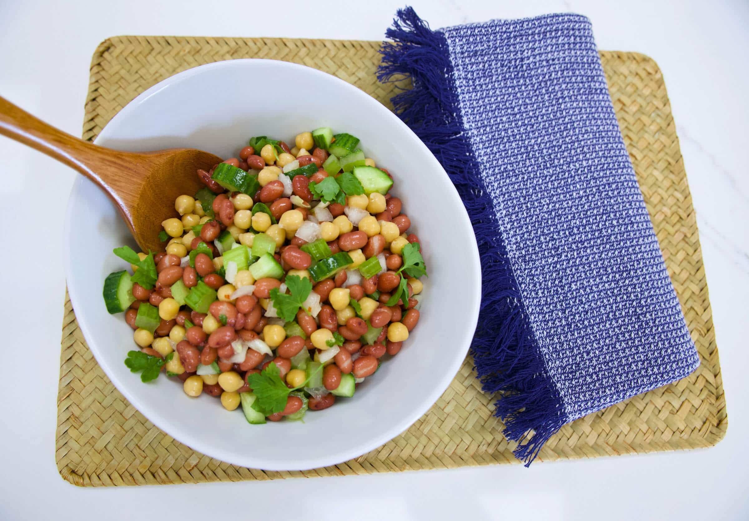 Bean salad with serving spoon inserted