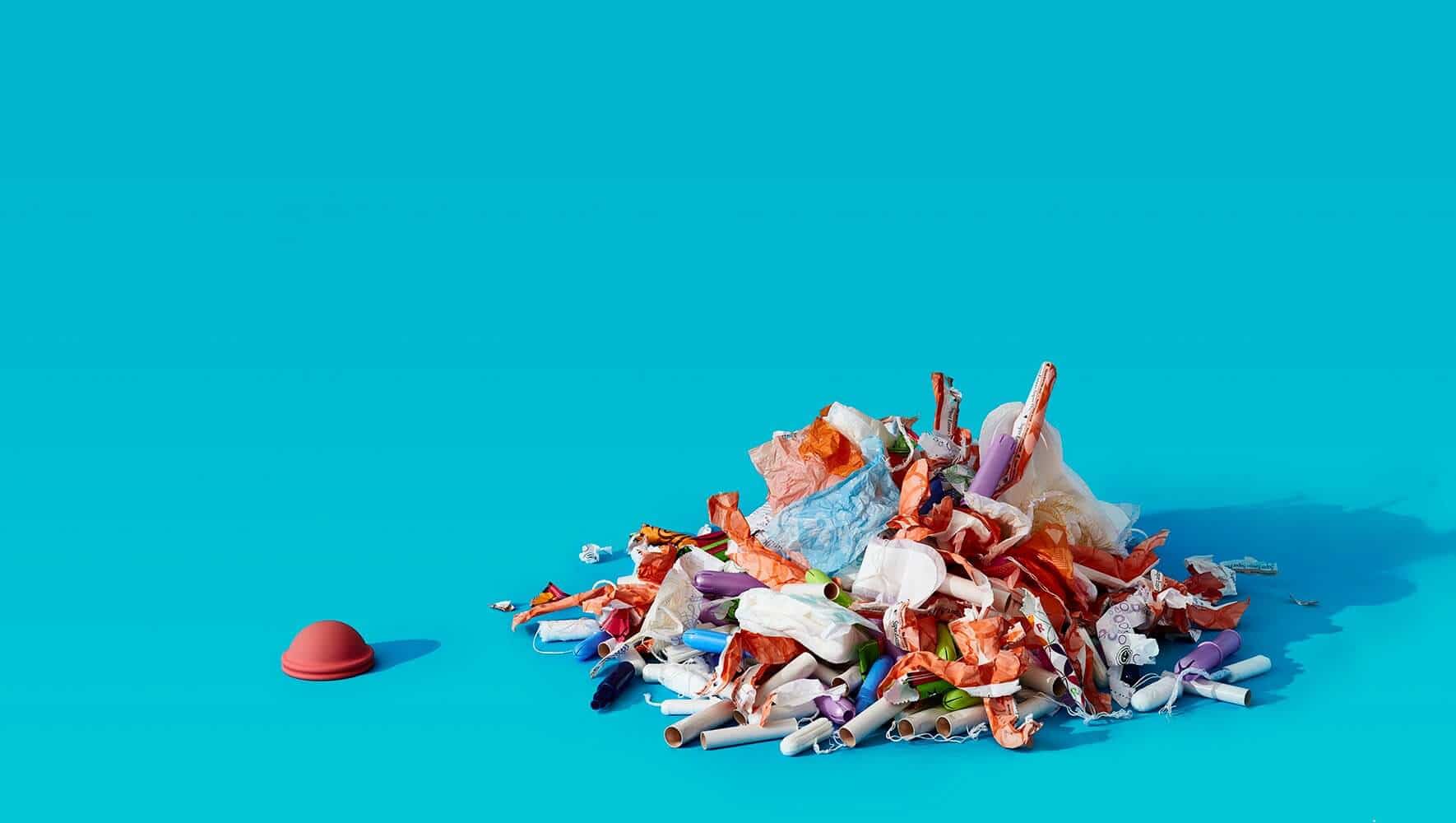  nixit menstrual disc next to a pile of used menstrual products