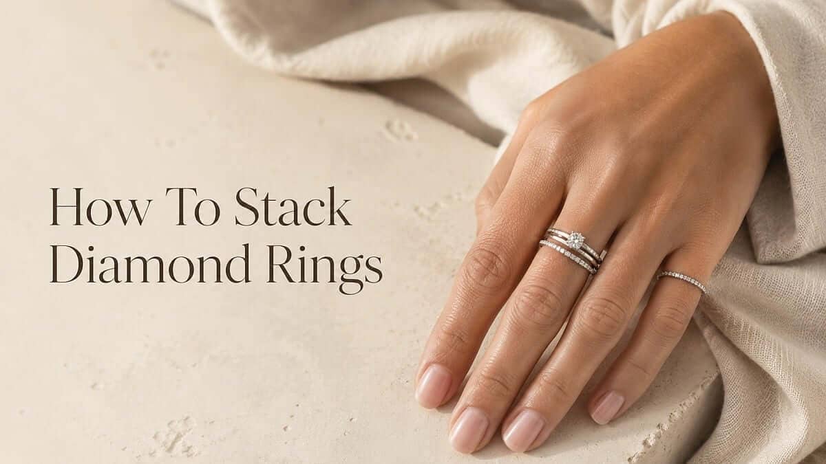 How to stack diamond rings illustrated with a female hand wearing 3 rings on the middle finger and a single ring on the little finger.