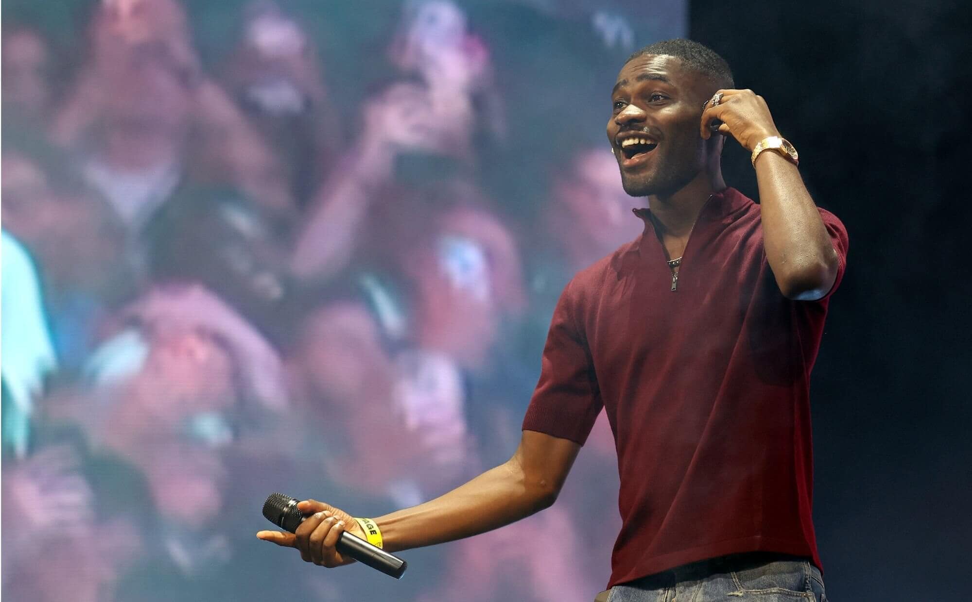 Dave performing live, credited to Simone Joyner/Getty Images