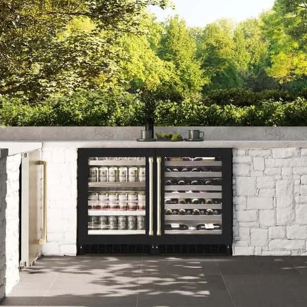 ZLINE Autograph Edition 24 in. Touchstone 151 Can Beverage Fridge With Black Matte Glass Door And Champagne Bronze Handle (RBSOZ-BLM-24-CB) installed on an outdoor patio