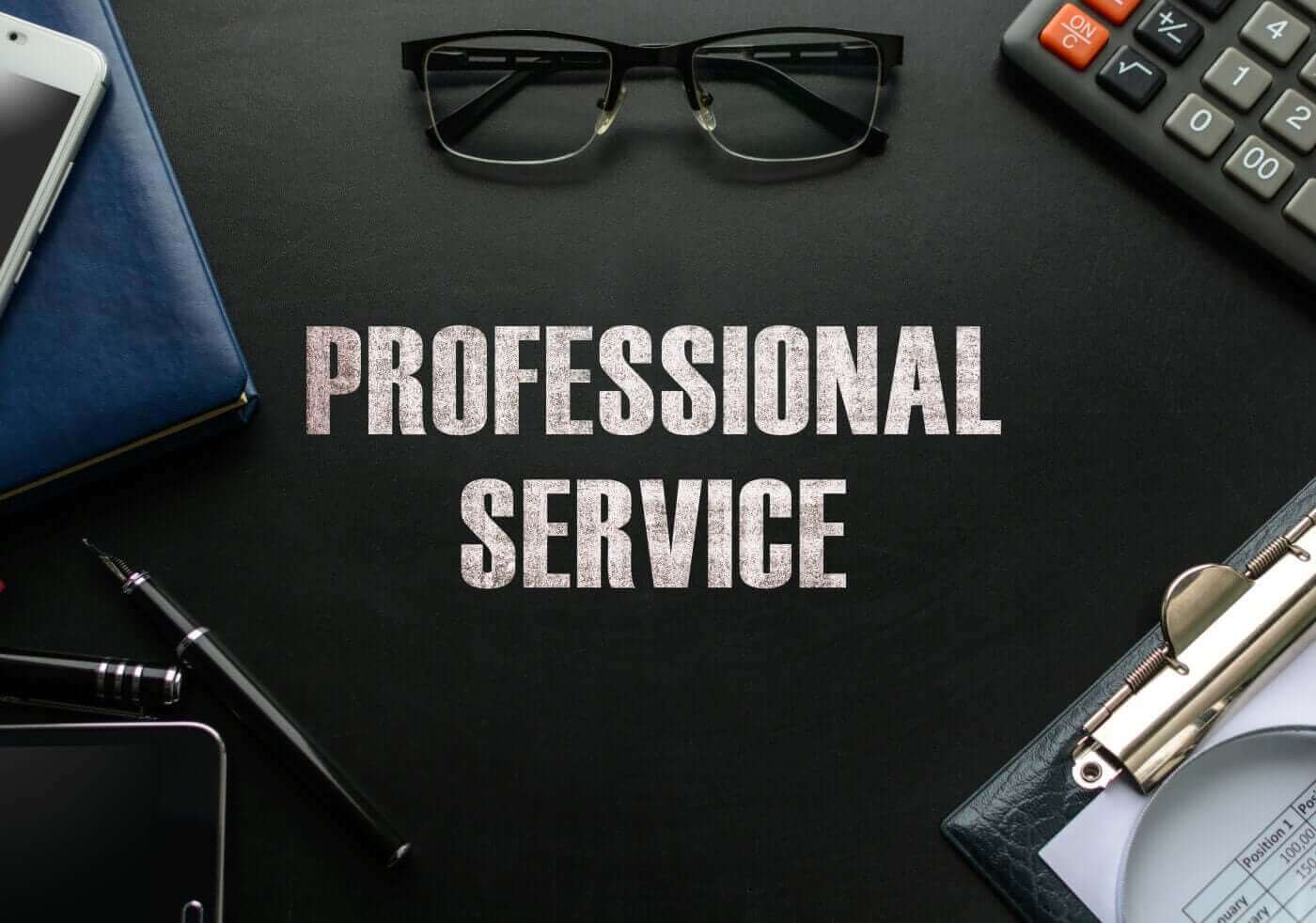 Desk flat lay reading Professional Service, representing a dedicated video redaction service provider